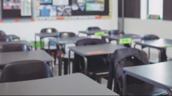 photo of empty desks in an empty classroom